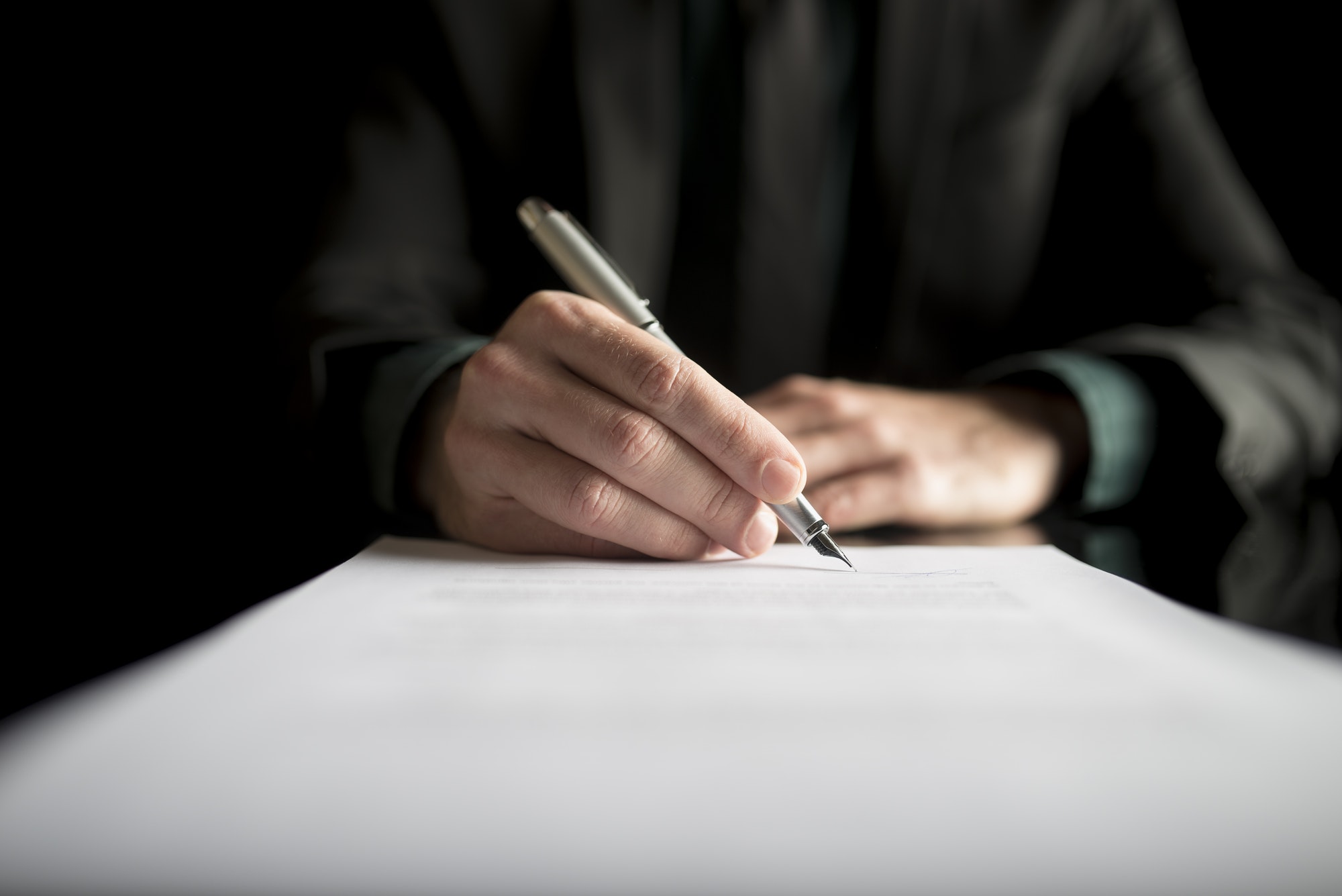 Closeup of lawyer or executive signing a contract
